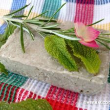 Green clay shampoo bar with herbs and flowers for decoration