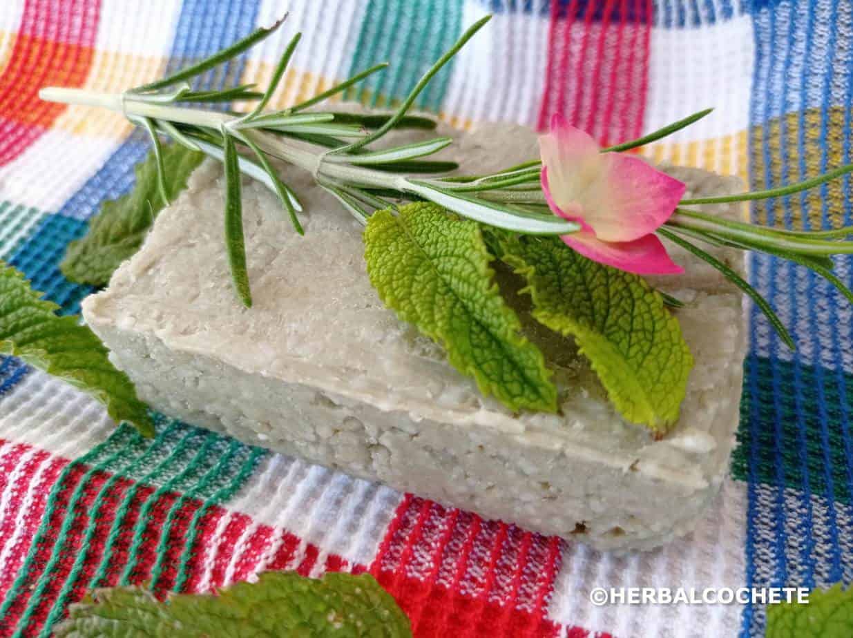 Green clay shampoo bar with herbs and flowers for decoration
