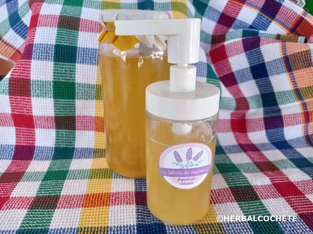natural homemade liquid soap in a soap dispenser and a mason jar, with colorful towel as background